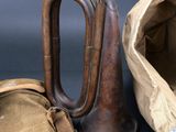 a bag and a trumpet sitting next to each other on a table