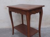 a small wooden table with a shelf on top of it