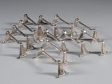 a lot of silver figurines that are standing in a line