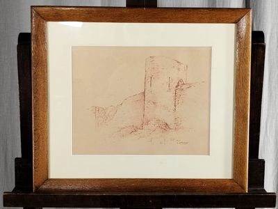 dessin représentant un château, encadré dans un cadre en bois posé sur une table