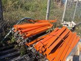 a pile of wood sitting on the ground next to a fence