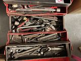 many tools in a red tool box on the floor