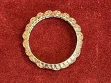 a close up of a gold ring on a red cloth