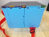 a small blue box with a red strap on it