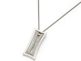 a close up of a necklace on a white surface with a chain