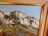 a painting of a mountain in a gold frame