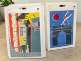 two boxes that have pictures on them on a table