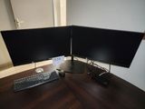 deux écrans d'ordinateur et un clavier sur un bureau