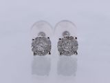 a pair of diamond earrings on a white surface