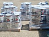 several cans of beer are stacked on pallets in a parking lot