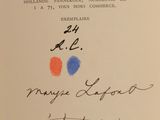 an open book with a handwritten title and a picture of a red, blue, and orange dot