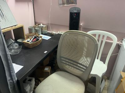 a desk with a chair and a computer on it