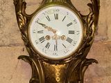 a gold clock on the wall of a building