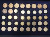 an assortment of gold coins in a display case