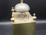 an antique brass clock with a bell on top of it