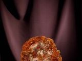 a slice of pizza sitting on a table with a black background