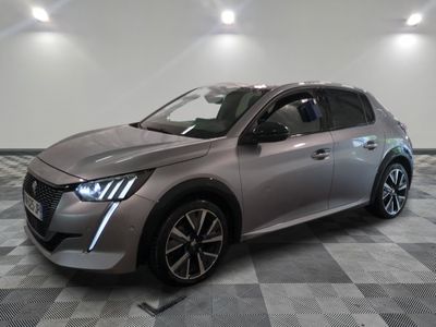 the silver car is parked on a checkered floor in a garage