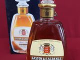 a bottle of liquor sitting on a table next to a box