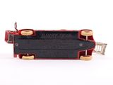 a red and black miniature train on a white surface