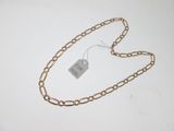 a chain with a tag attached to it on a table