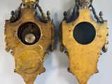 pair of antique brass clock faces on a white background