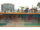 toy figurines of people and animals in a display case