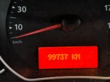 dashboard of a car with a speedometer and a red sticker