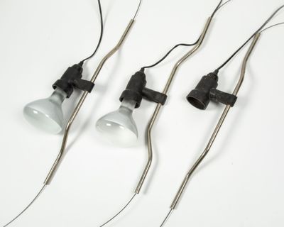 three light bulbs are attached to the wires of a lamp