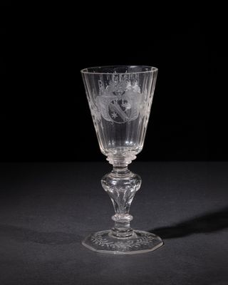 crystal goblet with a floral design on the stem of the goblet