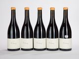 quatre bouteilles de vin sont alignées sur une surface blanche