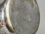a close up of a silver vase on a table