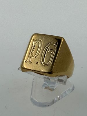 a gold signet ring with the word pgg on it