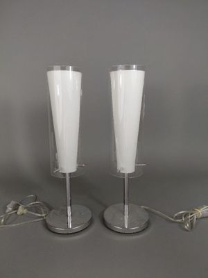 two wine glasses sitting on a table next to each other