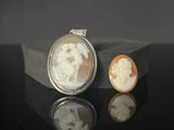 a close up of a piece of jewelry with a picture of a man and a woman