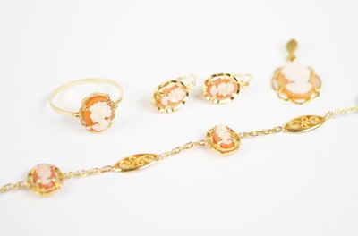several pieces of jewelry sitting on top of a white surface