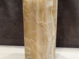 a marble vase sitting on a table with a black background