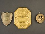 three different types of badges are shown on a black surface