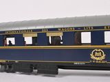 a blue and yellow train car with people inside of it
