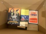 many books in a box that are sitting on top of each other