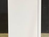 a white refrigerator sitting on the floor in a room