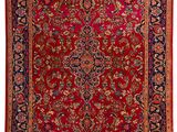 a red and black rug with a floral design on it