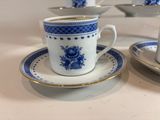 a cup and saucer on a table with a plate on it