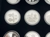 a close up of a display case with a number of silver coins
