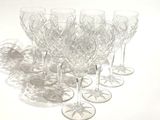 several empty wine glasses sitting on a white surface with a shadow