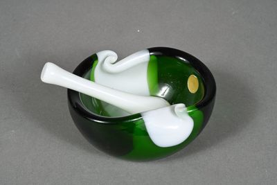 a green and white bowl with a pipe in it