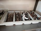 a lot of utensils and spoons in a drawer