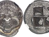 an image of a silver coin with a face and a cross on it