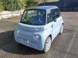 a small blue car parked in a parking lot