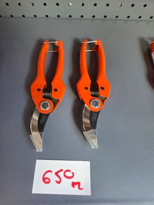three orange pliers are on display in a store for sale