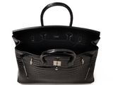 a black crocodile skin handbag with a metal handle on a white background